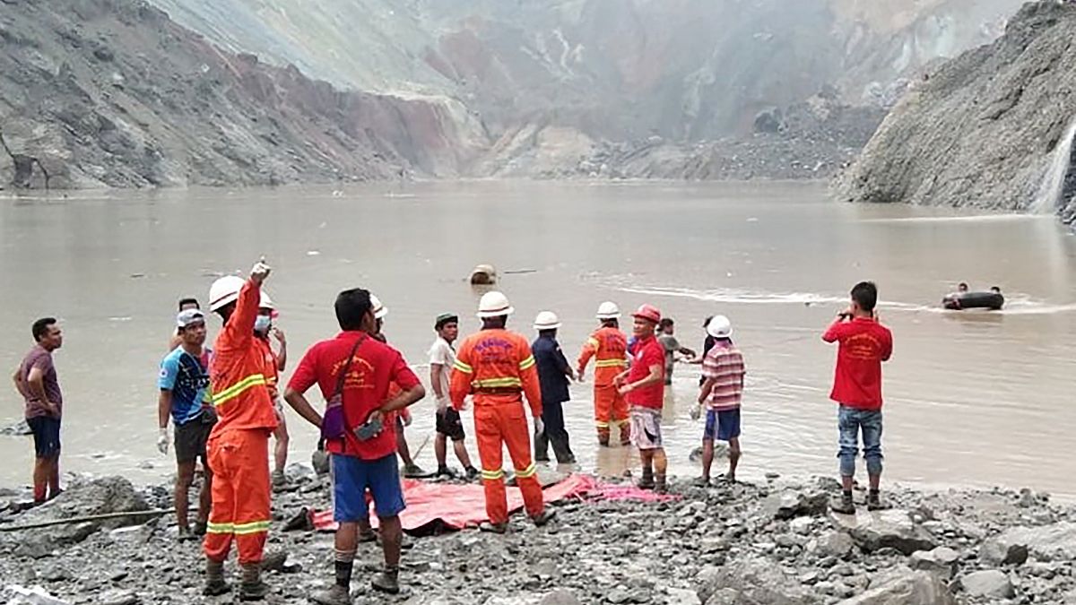 Myanmar Fire Services Department rescuers attempting to locate survivors after a landslide at a jade mine on July 2, 2020.