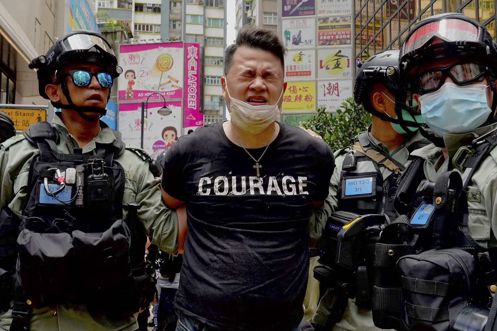 Police detain a protester after dispersing pepper spray during a protest in Causeway Bay before the annual handover to China march in Hong Kong. 1 July 2020