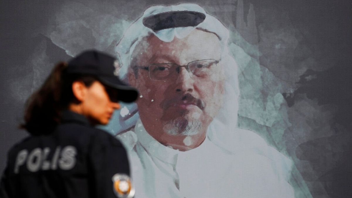 A Turkish police officer walks past a picture of slain Saudi journalist Jamal Khashoggi prior to a ceremony, near the Saudi Arabia consulate in Istanbull - Oct. 2, 2019 (file)