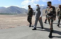 In this handout photo provided by the Press Information Bureau, Indian Prime Minister Narendra Modi walks with soldiers during a visit to the Ladakh area, India, Friday, July 