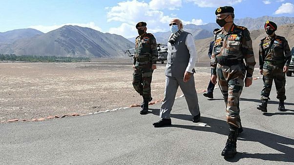 In this handout photo provided by the Press Information Bureau, Indian Prime Minister Narendra Modi walks with soldiers during a visit to the Ladakh area, India, Friday, July In this handout photo provided by the Press Information Bureau, Indian Prime Minister Narendra Modi walks with soldiers during a visit to the Ladakh area, India, Friday, July