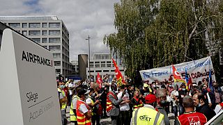Air France workers gather during a protest in front of the company headquarters in Tremblay-en-France, outside Paris.