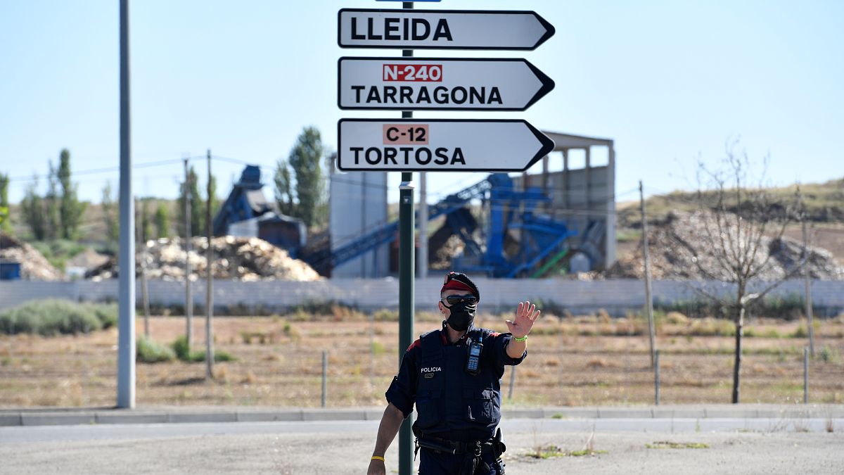 A member of the Catalan regional police force Mossos d'Esquadra controls a checkpoint on the road leading to Lleida on July 4, 2020