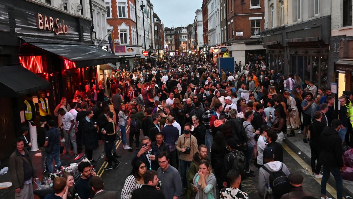 Revellers pack a street outside bars in the Soho area of London on July 4, 2020