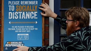 A pub owner put signs in place instructing on social distancing at the Chandos Arms pub in London, Wednesday, July 1, 2020.