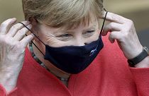German Chancellor Angela Merkel adjusts her face mask as she arrives for a meeting of the upper house of the German legislative in Berlin, Germany, Friday, July 3, 2020.