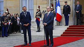 Outgoing French Prime Minister Edouard Philippe, left, speaks while newly named Prime Minister Jean Castex listens after the handover ceremony in Paris.