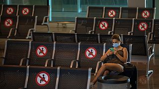 A passenger sits at Barcelona airport in Barcelona, Spain, Tuesday, June 30, 2020.