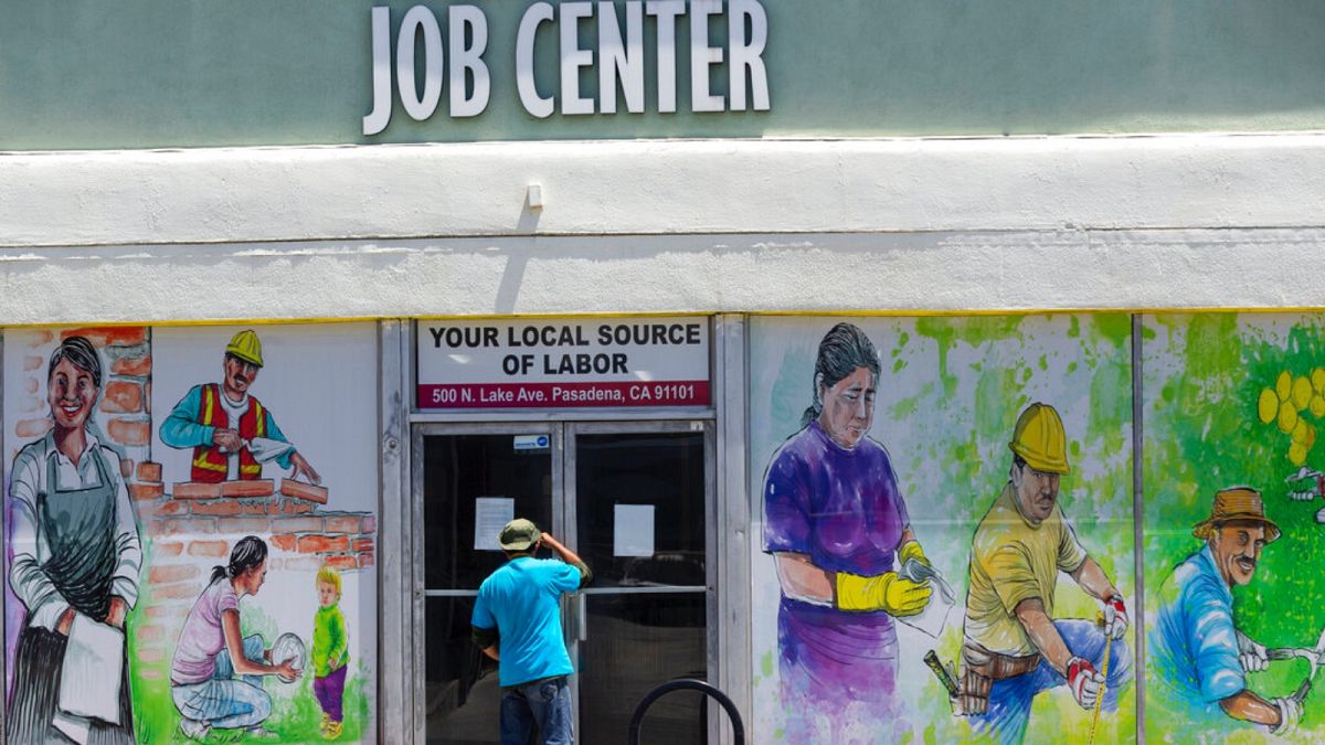 a person looks inside the closed doors of the Pasadena Community Job Center in Pasadena, Calif., during the coronavirus outbreak, May 7, 2020 (file)
