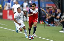 FC Dallas defender Ryan Hollingshead plays the ball while Minnesota United forward Miguel Ibarra chases him during the first half of an MLS soccer match in Frisco, Texas.