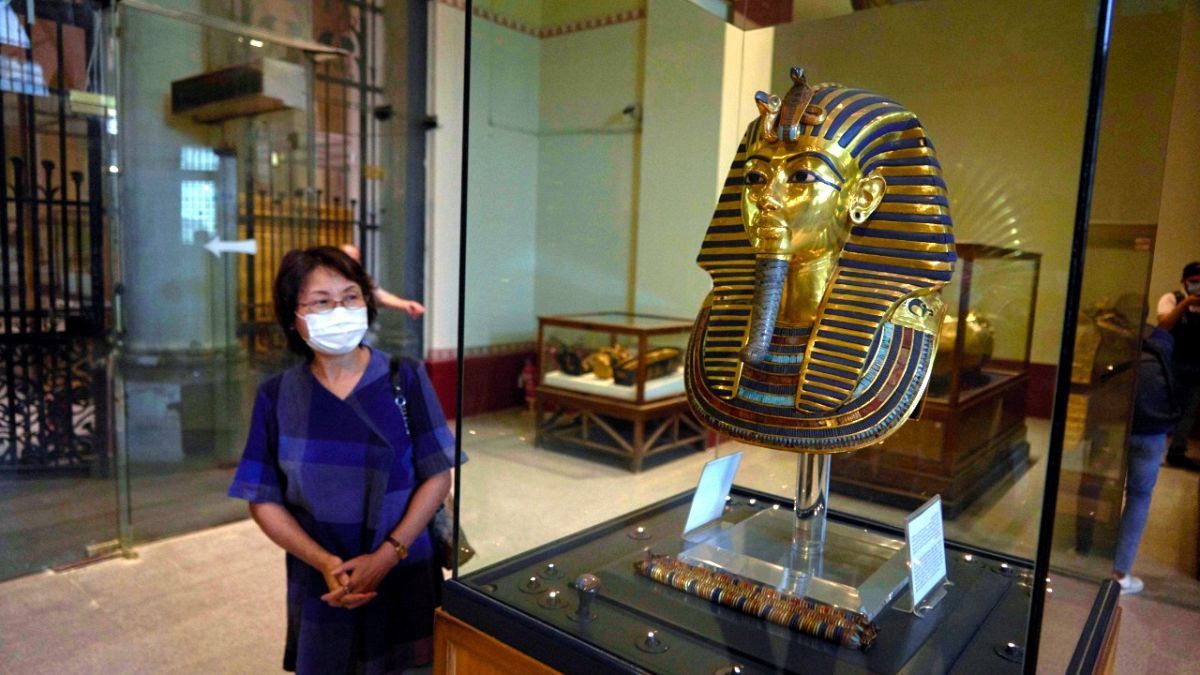 A Japanese tourist visits the golden mask of King Tut on display at the Egyptian Museum in downtown Cairo, Egypt