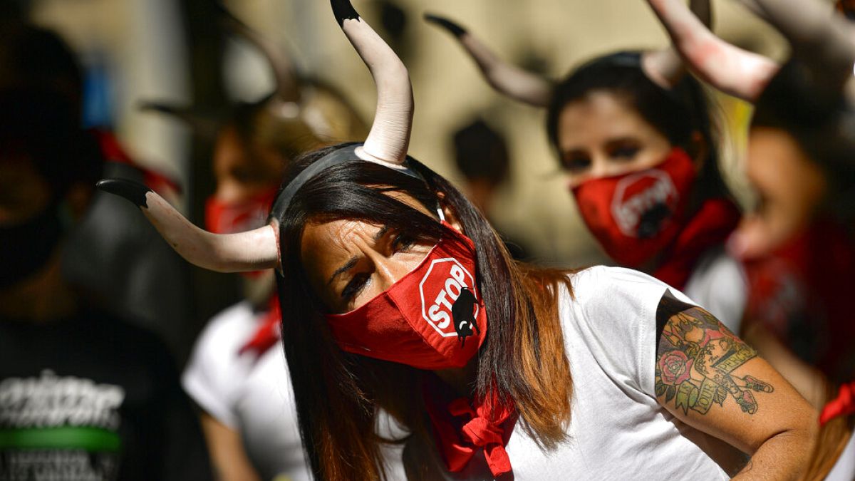 Demonstrators wear faces masks while protesting against San Fermin's bullfighting, canceled this year by the conoravirus pandemic, in Pamplona, northern Spain, Tuesday, July 7