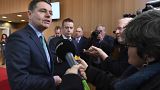 Irish Finance Minister Paschal Donohoe, left, speaks with the media prior to a meeting of the eurogroup at the EU Council building in Brussels on Monday, Feb. 19, 2018.