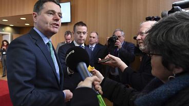 Irish Finance Minister Paschal Donohoe, left, speaks with the media prior to a meeting of the eurogroup at the EU Council building in Brussels on Monday, Feb. 19, 2018.