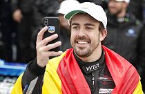 Fernando Alonso, of Spain, takes a selfie photo in Victory Lane after winning the 24 hour race at Daytona International Speedway, 2019