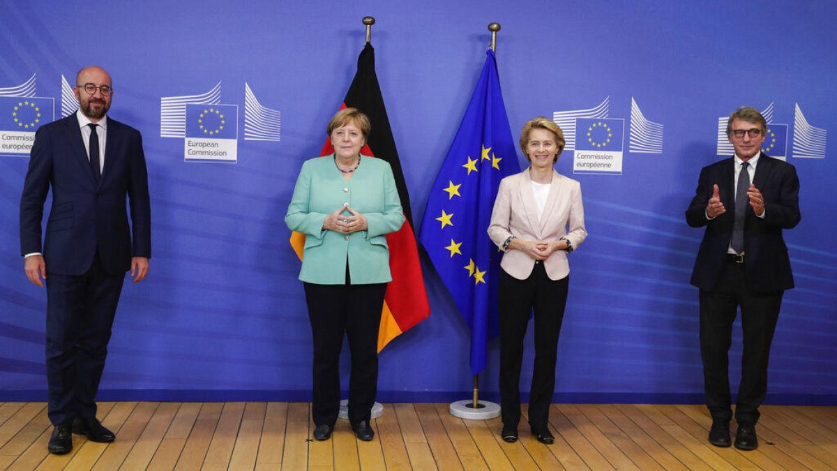 Charles Michel, Angela Merkel, Ursula von der Leyen and David Sassoli pose for photographers prior to a meeting at EU headquarters in Brussels.