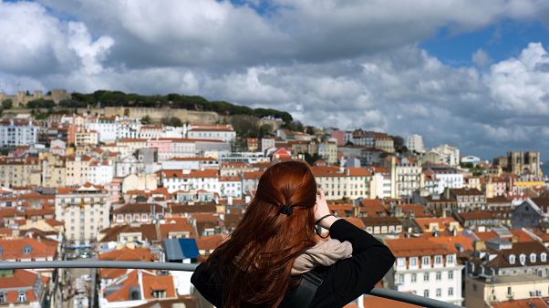 A woman takes pictures from the top of Lisbon A woman takes pictures from the top of Lisbon