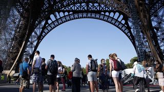 People queue up prior to visit the Eiffel Tower, in Paris, Thursday, June 25, 2020. 