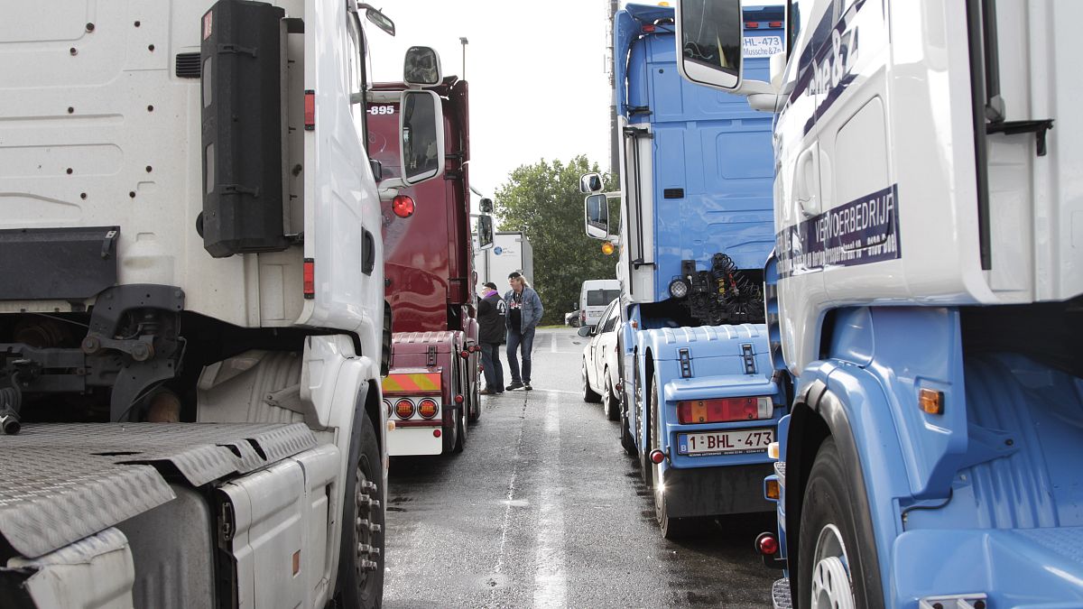 Truckers gather to perform a 'drive slow' action to Brussels at a tank station in Waarloos, Belgium on Monday, Sept. 24, 2012. 