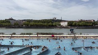 People visit a swimming pool in the center of Lyon, central France, Tuesday, June 25, 2019.