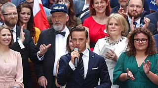 Krzysztof Bosak, centre, of the far-right party Confederation, addresses a pre-election convention in Warsaw.