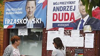 Campaign posters for two contenders in Poland's key presidential election runoff Sunday, in Raciaz, Poland.