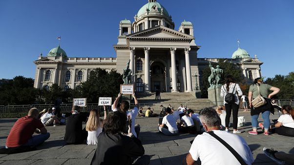 People sit during a protest in front Serbian Parliament building in Belgrade, Serbia,Thursday, July 9, 2020. People sit during a protest in front Serbian Parliament building in Belgrade, Serbia,Thursday, July 9, 2020.