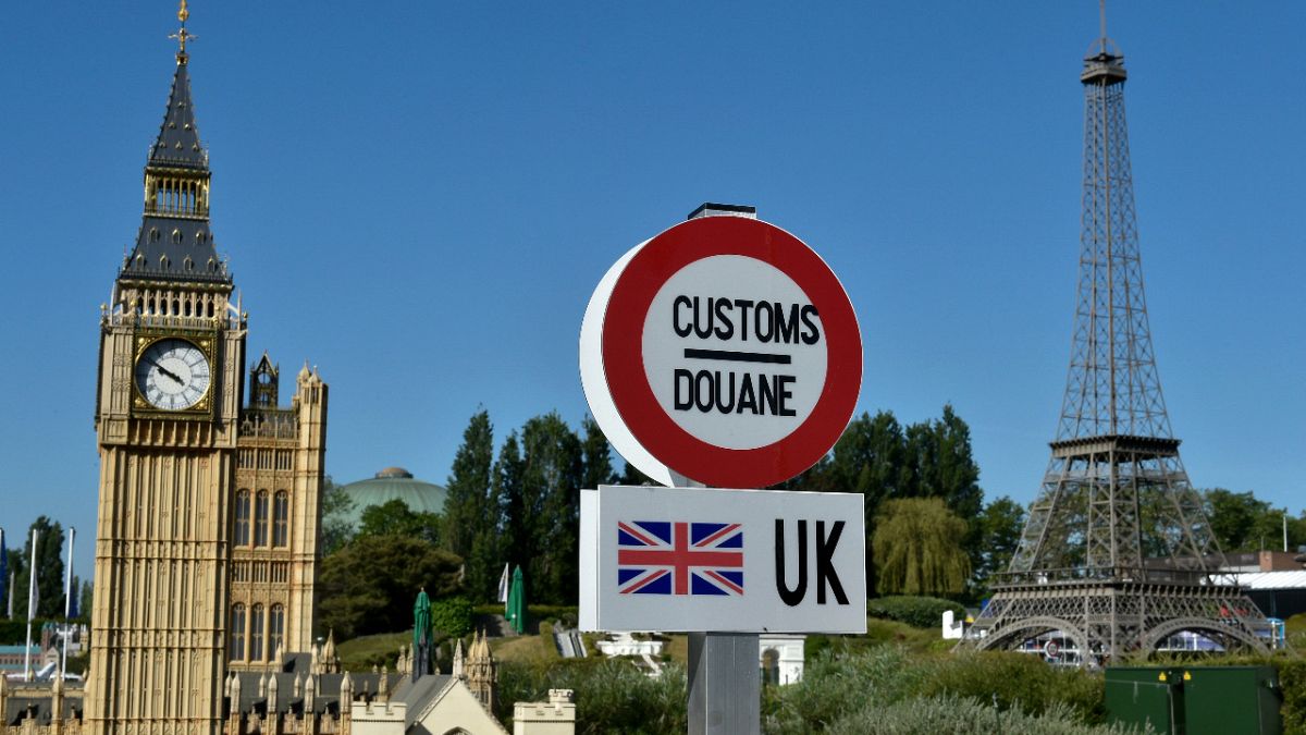 A model of a customs road sign is seen at the mock EU-UK border, with a model of Big Ben and the Eiffel Tower, at a 'Mini-Europe' theme park  in Brussels on May 20, 2020. 