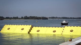 Moveable flood gates rise from the sea in the Venice lagoon, Italy, Friday, July 10, 2020.