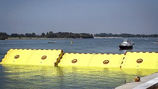 Moveable flood gates rise from the sea in the Venice lagoon, Italy, Friday, July 10, 2020. 