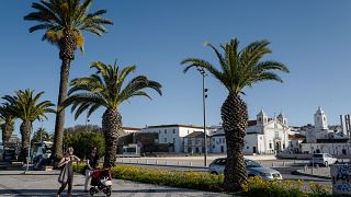 People walk in the old city center of Silves on April 18, 2018 in the southern Portugal region of Algarve. 