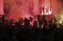 Protesters clash with riot police on the steps of the Serbian parliament during a protest in Belgrade, Serbia, Friday, July 10 2020. 