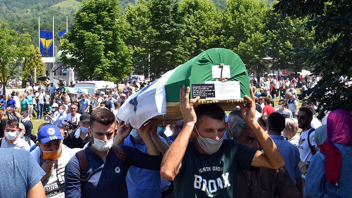Bosnian Muslim men carry the casket of a newly identified victim during a burial ceremony marking the 25th anniversary of the Srebrenica massacre, Potocari, Bosnia, 11/7/20. 