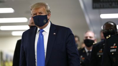 President Donald Trump wears a face mask as he walks down a hallway during a visit to Walter Reed National Military Medical Center in Bethesda, Md., Saturday, July 11, 2020.