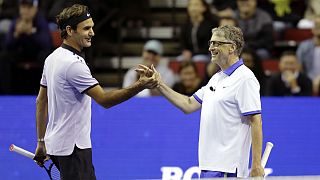 Roger Federer, of Switzerland, left, and Microsoft founder Bill Gates, right