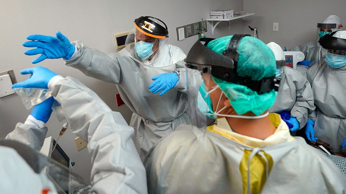 Dr. Joseph Varon reaches for an IV bag inside the Coronavirus Unit at United Memorial Medical Center in Houston, USA. July 6, 2020 