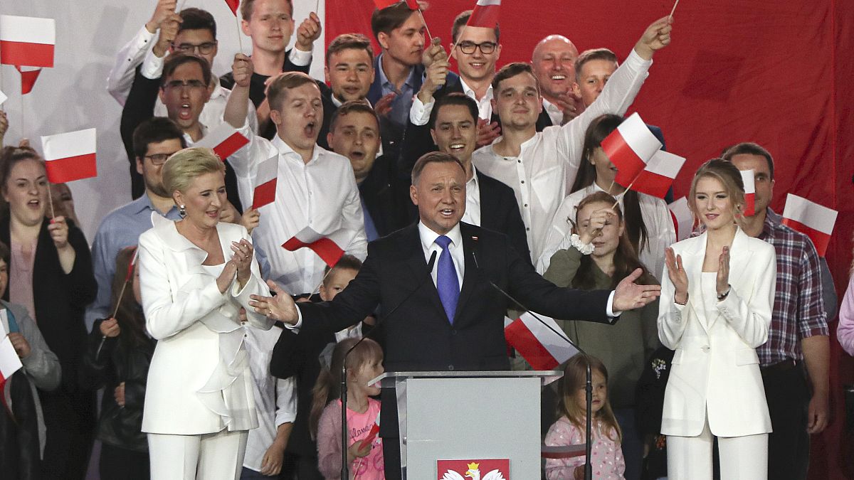 Incumbent President Andrzej Duda, center, gestures next to his wife Agata Kornhauser-Duda