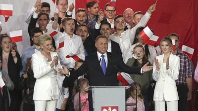 Incumbent President Andrzej Duda, center, gestures next to his wife Agata Kornhauser-Duda