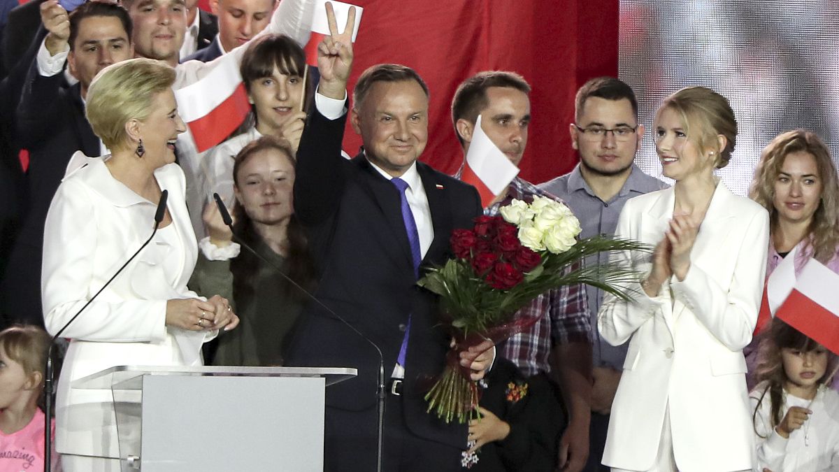 Incumbent President Andrzej Duda flashes a victory sign in Pultusk, Poland, Sunday, July 12, 2020.