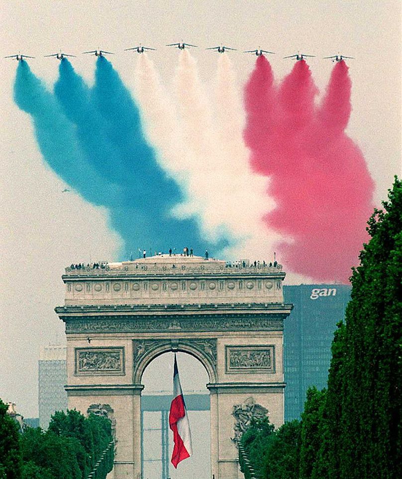 French Alpha Jets sweep over the Arc de Triomphe during the July 14 military parade. For the first time, planes from the British Royal Air Force join the display of 156 aircraft as a tribute to Franco-British military cooperation. 1996 THOMAS COEX/AFP