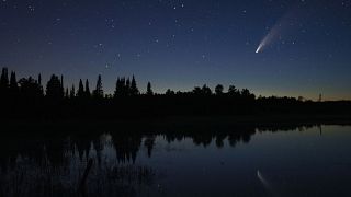 Comet Neowise streaks across the night sky over Wolf Lake in Brimson, Minnesota, USA. July 14, 2020