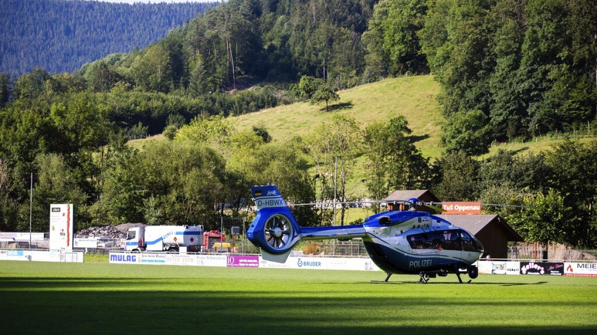 A police helicopter stands on a sports field in Oppenau, southern Germany.