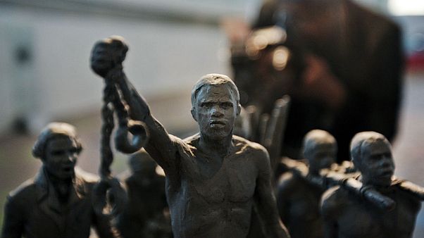 A man photographs a maquette of a status which stands as a permanent slavery memorial statue, City Hall, London A man photographs a maquette of a status which stands as a permanent slavery memorial statue, City Hall, London