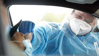 Shania Dod, right, collects a sample at a United Memorial Medical Center COVID-19 testing site Wednesday, July 8, 2020, in Houston.