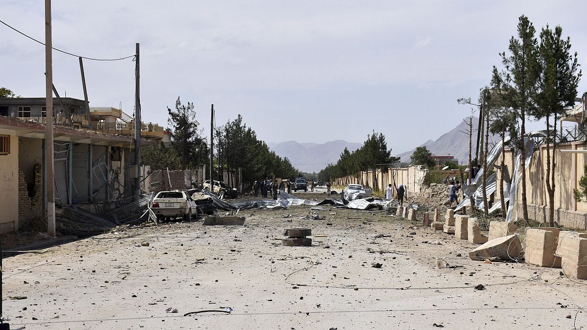 Afghan security personnel inspect the site of a car bomb blast on an intelligence compound in Aybak, northern Afghanistan, Monday, July 13, 2020.