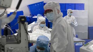 Workers at a production line for masks in Wuhan, where the coronavirus outbreak began