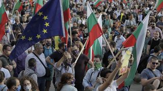 Protesters wave Bulgarian and EU flags as they take part in anti-governmental protest in downtown Sofia on Monday, July 13, 2020.