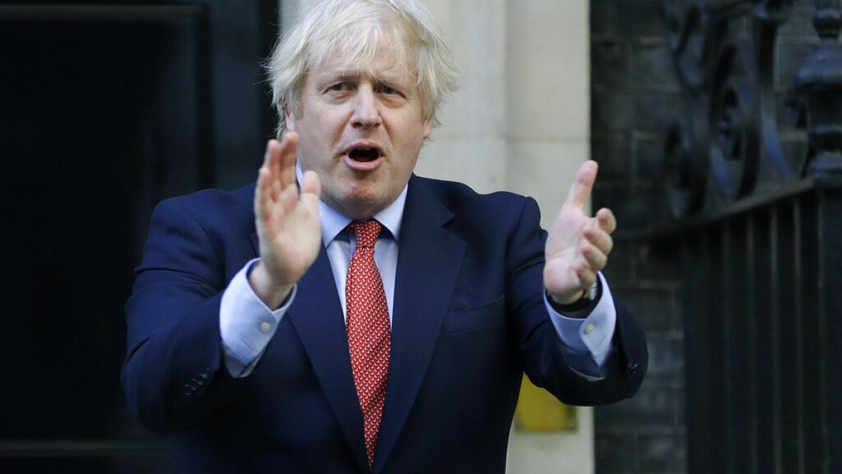 PM Boris Johnson applauds health and care workers during the UK's COVID-19 outbreak