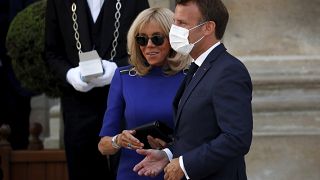 El presidente francés Emmanuel Macron lleva una mascarilla al salir con su esposa Brigitte después de dar un discurso a las Fuerzas Militares Francesas en el Hotel de Brienne.