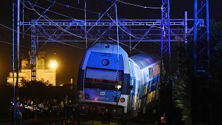 Rescuers work at the scene of a passenger and freight trains collision in Cesky Brod, east of Prague,